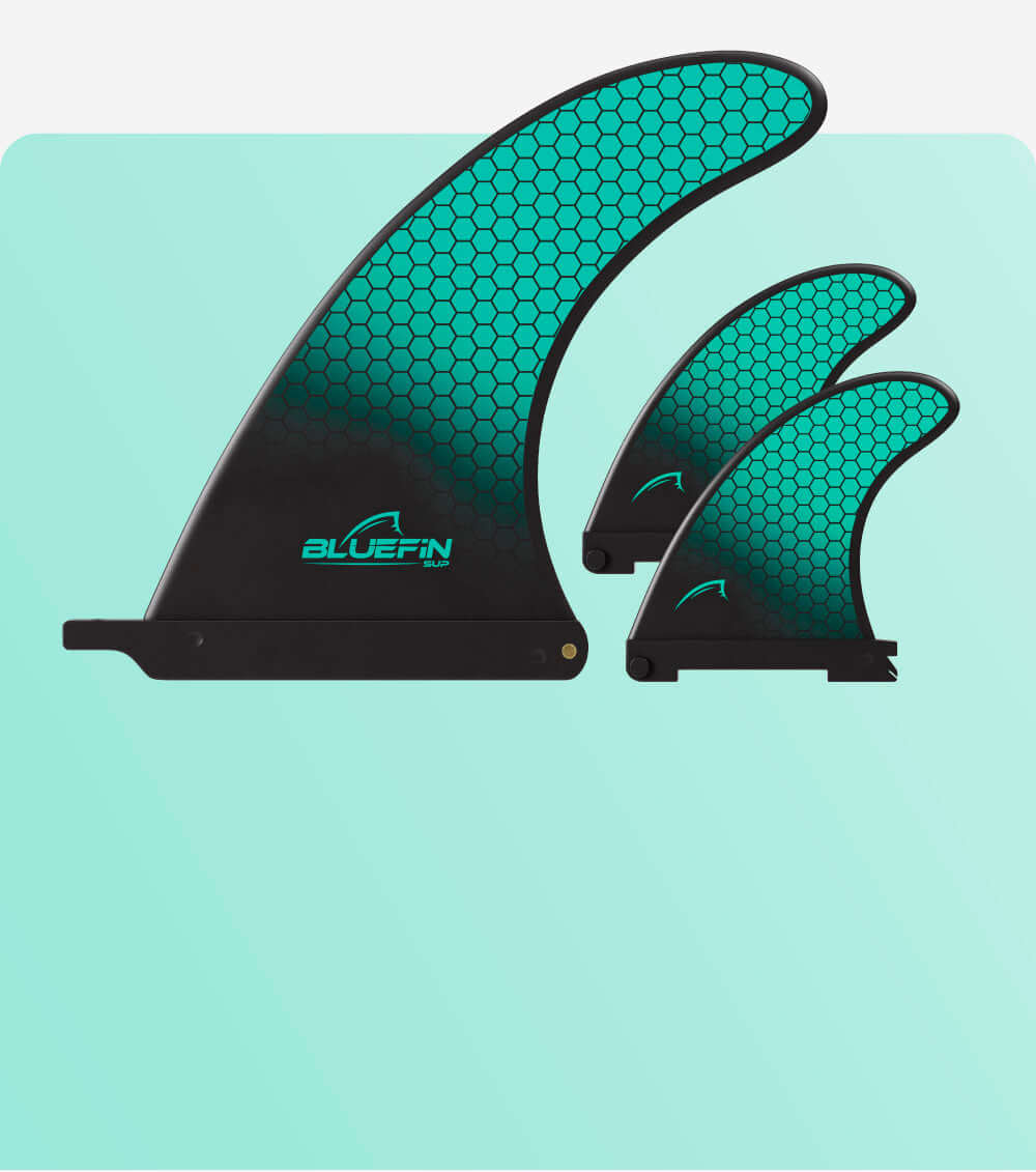 Three Bluefin SUP fins in varying sizes with a turquoise honeycomb pattern on a light background.