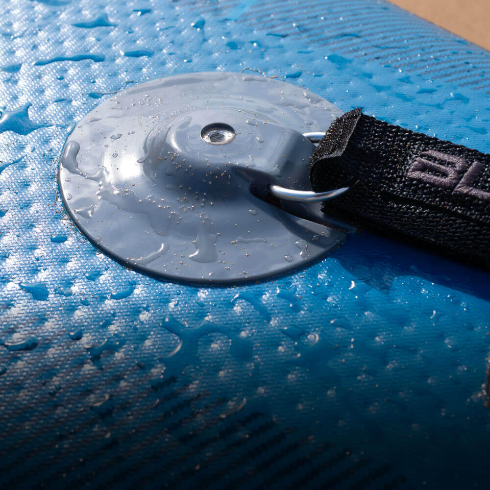 Close-up of a blue inflatable paddleboard's valve with water droplets and a black strap