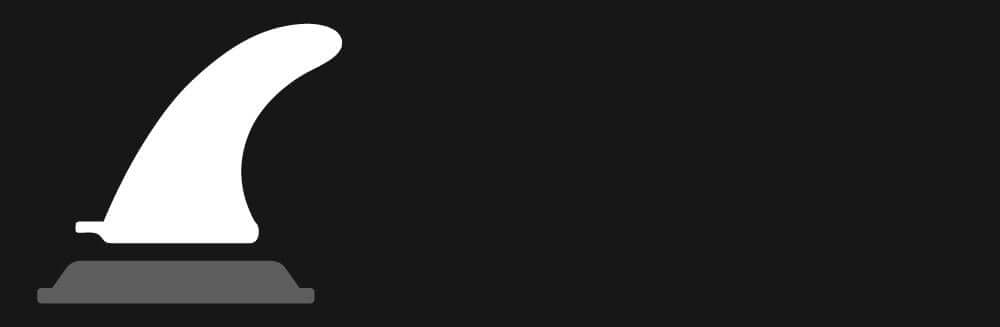 White surfboard fin on a gray base against a black background, showing its curved shape and design.