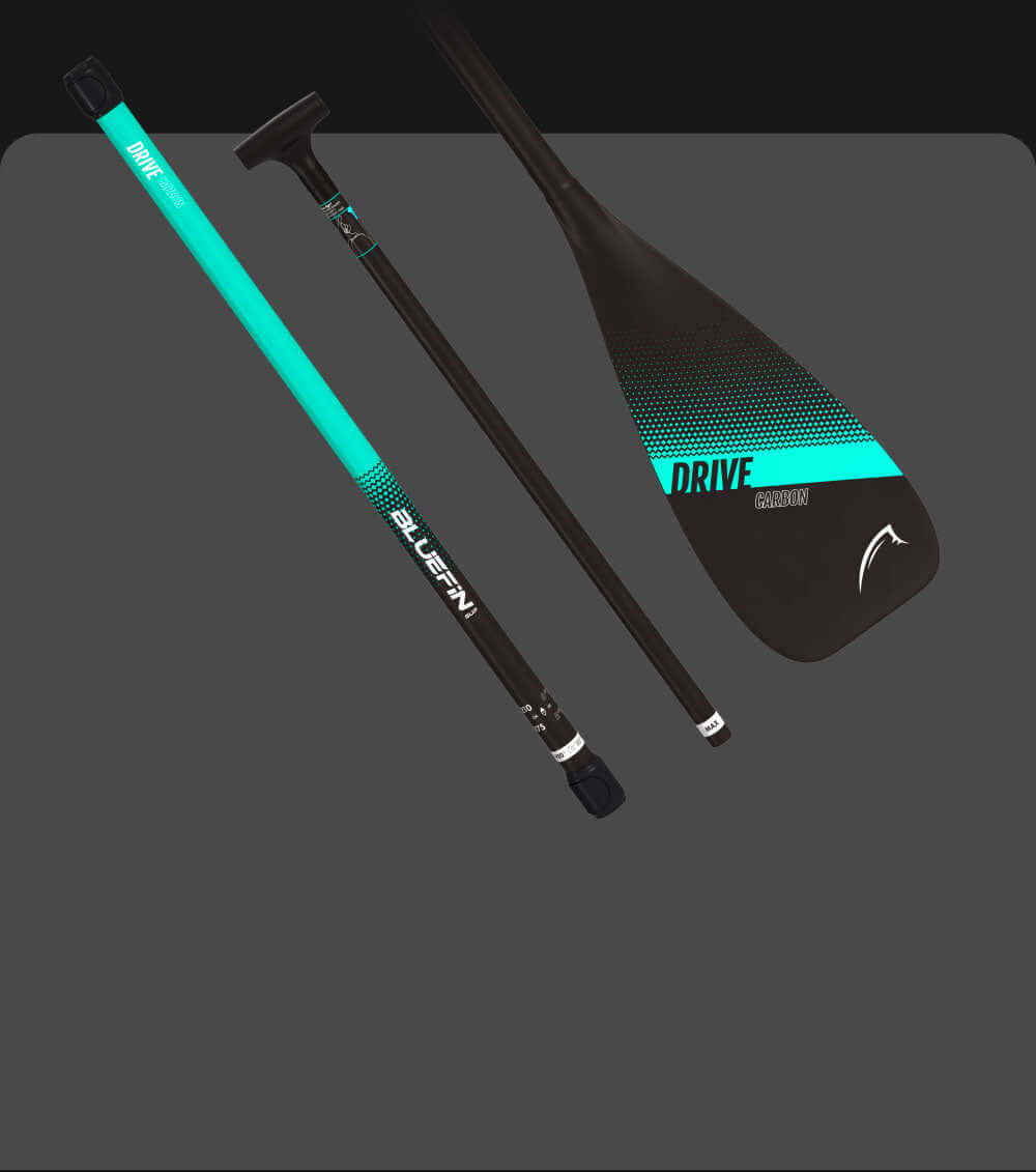 Carbon paddle with turquoise accents, featuring a textured grip and a wide blade for efficient strokes.