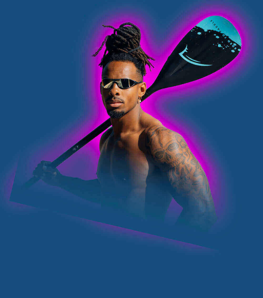 Muscular person with tattoos holding a paddle, wearing sunglasses, against a blue and pink background.