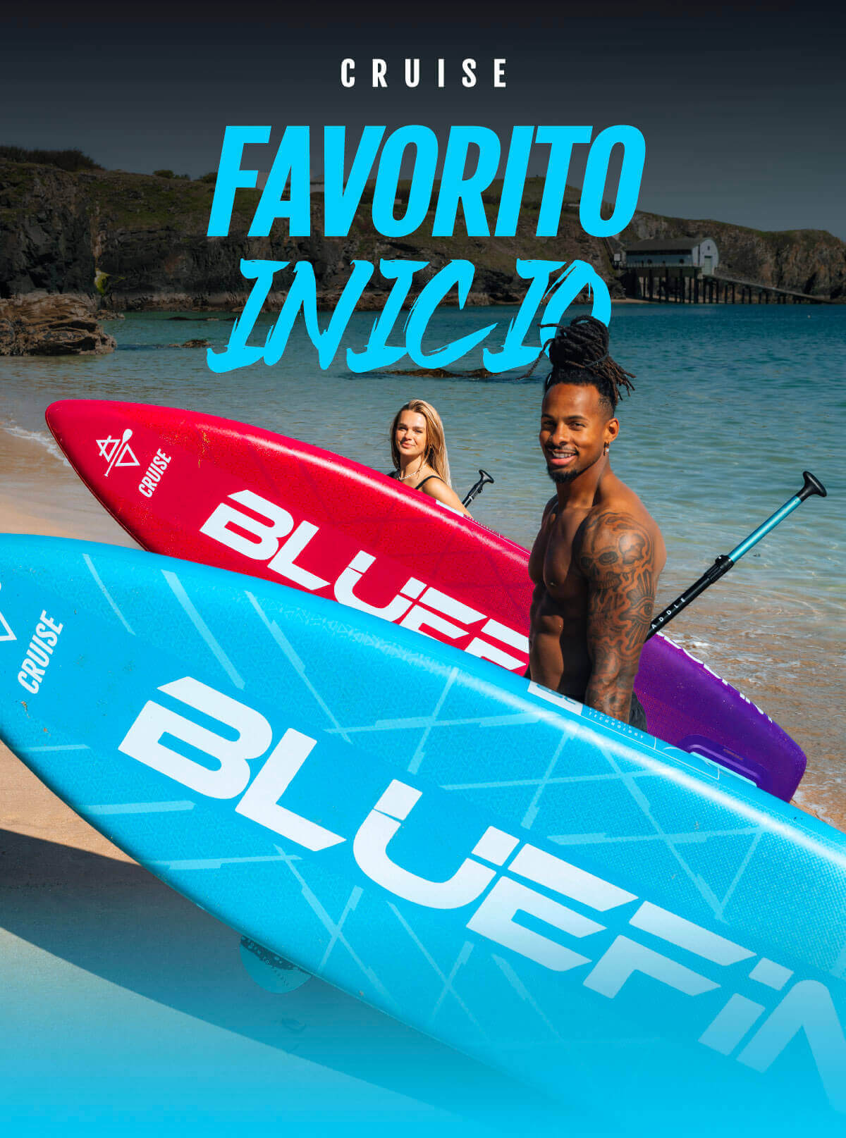 Two paddleboarders on colorful boards, one blue and one red, in shallow water with beach background.