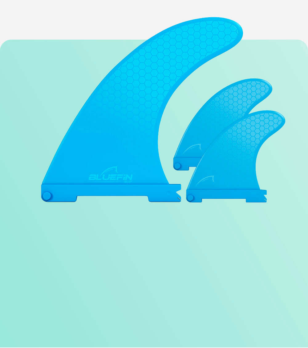 Three blue surfboard fins with a honeycomb pattern, varying in size, on a light green background.