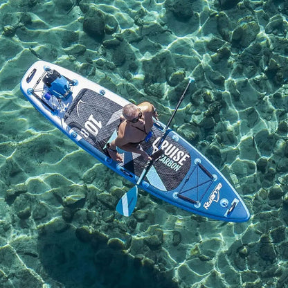 Person paddling a blue inflatable paddleboard over clear water with visible rocks below