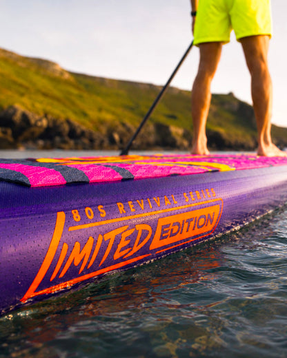 Inflatable paddleboard with purple and pink design, featuring 'Limited Edition' text and a textured deck.